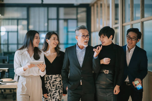istock group of asian chinese successful office management team having discussion while walking toward camera 1284346706