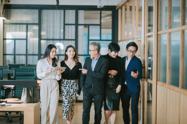 istock group of asian chinese successful office management team having discussion while walking toward camera 1284346717