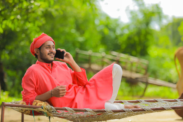 istock Young Indian farmer talking on mobile phone and showing happy expression 1284348536
