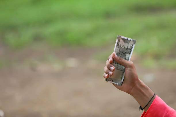 istock man holding indian money note in hand 1284349385