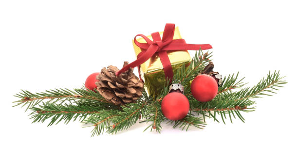 istock Present box wrapped into golden foil on green fir needle branches isolated on white 1284349398
