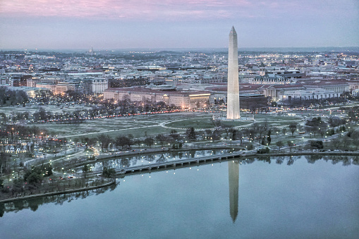 Sunset of the District of Columbia with the Washington Monument reflecting from the Potomac River in Washington, D.C.