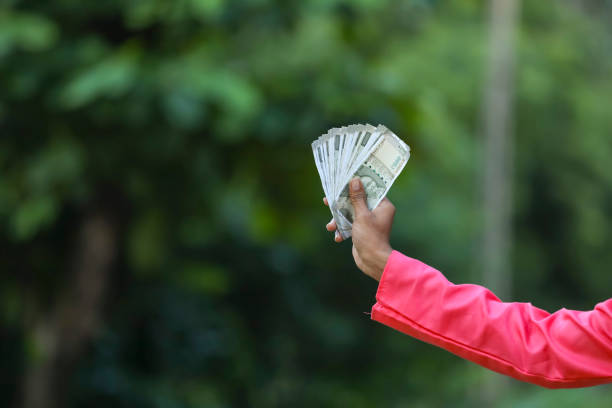 istock man holding indian money note in hand 1284350399
