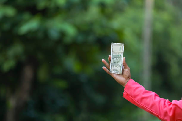 istock man holding indian money note in hand 1284350420