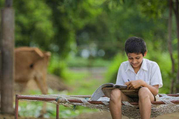 Cute Indian child studying at home.