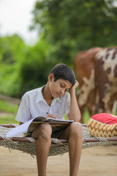istock Cute Indian child studying at home. 1284350516
