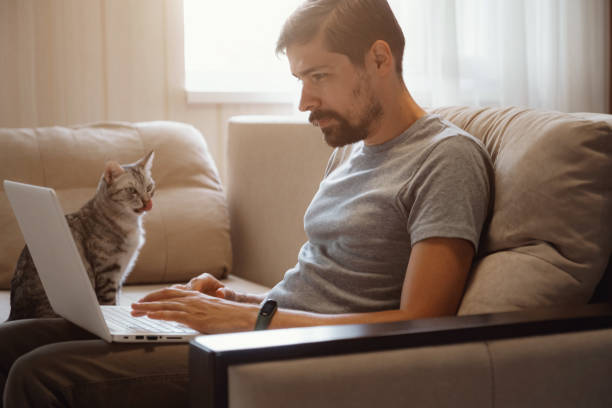 istock Young attractive smiling guy is browsing at his laptop 1284350522