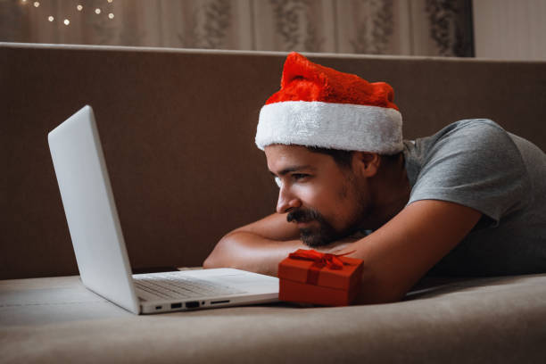 istock A hipster man with a red cup sitting at home at Christmas time. 1284350525