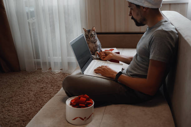 istock A hipster man with a red cup sitting at home at Christmas time. 1284351260