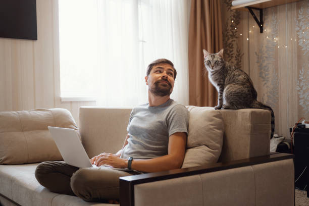 istock Young attractive smiling guy is browsing at his laptop 1284351276