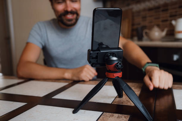 istock Young man having video call via smartphone in the home office. 1284351521