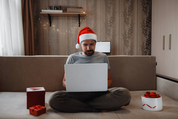 istock A hipster man with a red cup sitting at home at Christmas time. 1284351588