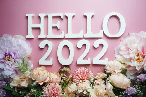 istock Hello 2022 alphabet letter with flower decoration on pink background 1284352198