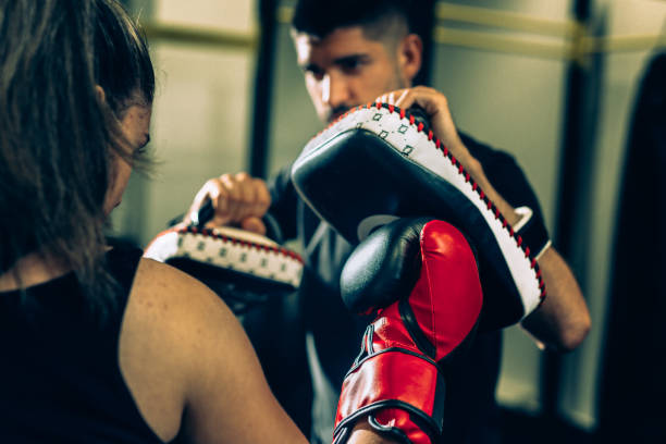 istock woman with her trainer preparing form boxing 1284352576