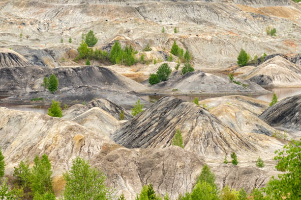 istock hills on an abandoned clay quarry, orange and black soil 1284355770