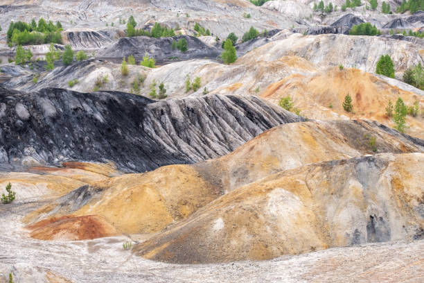 istock sludge pit with hills and orange soil, contaminated land with industrial waste 1284355779