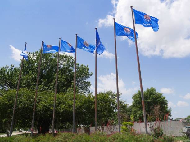 istock Flags of Oklahoma State flying from poles against blue and white clouds. 1284356431