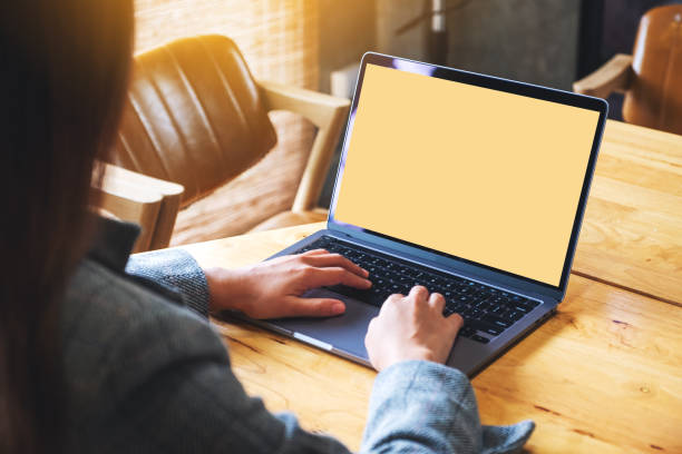 istock a businesswoman using and typing on laptop computer keyboard with blank white desktop screen on wooden table 1284360127
