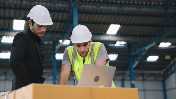 istock Two factory workers working and discussing manufacturing plan in the factory . 1284361901