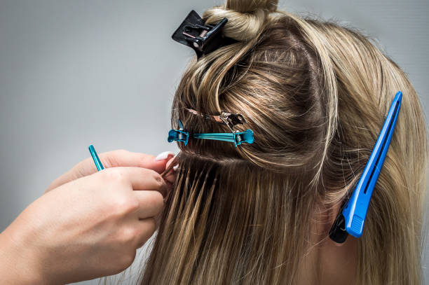 istock Hot hair extension process close up 1284363019