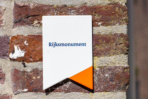 Well, the Netherlands - Sept 6, 2020: Rijksmonument is Dutch for a National Monument sign with is placed on a monument in the Netherlands