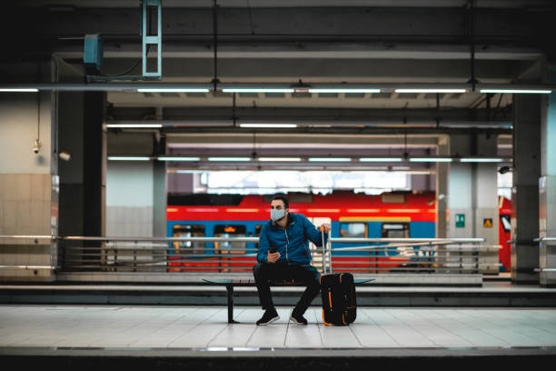 istock Young Caucasian man wearing protective face mask at metro station 1284363974