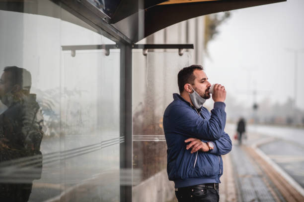 istock Young man waiting for transportation on a bus station 1284364266