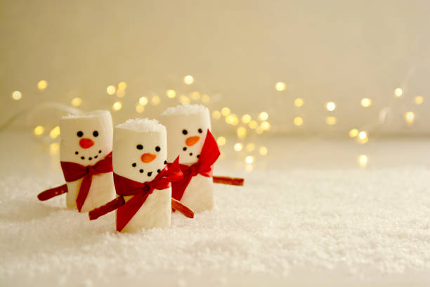 istock Marshmallow Snowmen Christmas abstract mockup with bokeh lights 1284366543