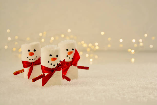 istock Marshmallow Snowmen Christmas abstract mockup with bokeh lights 1284366566