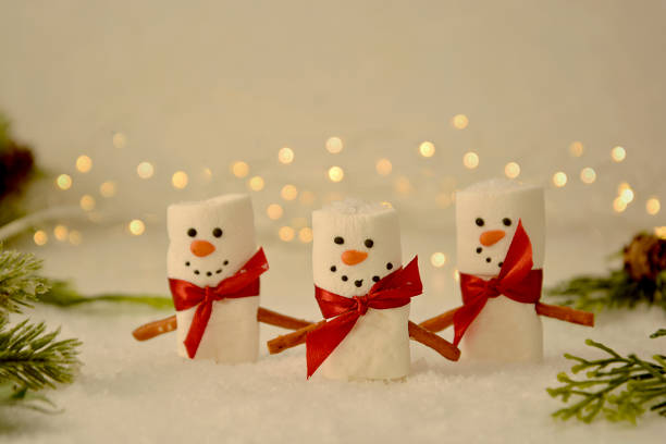 istock Marshmallow Snowmen Christmas abstract mockup with bokeh and fir branches 1284366582