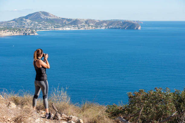 istock Woman hiking up the mountain 1284366688