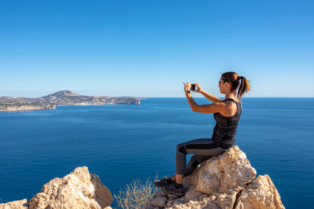 istock Woman hiking up the mountain 1284366735