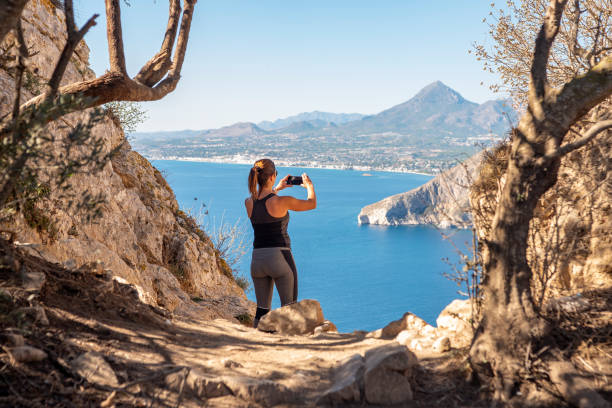 istock Woman hiking up the mountain 1284366779