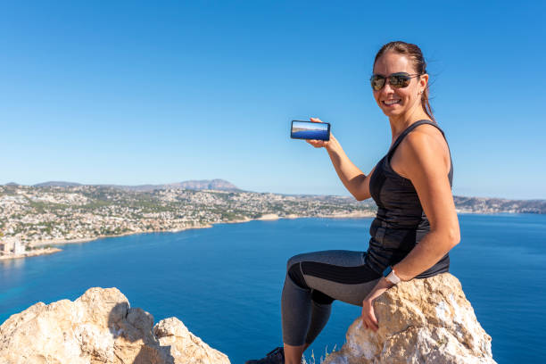 istock Woman hiking up the mountain 1284366788