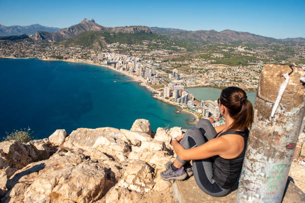istock Woman hiking up the mountain 1284366792