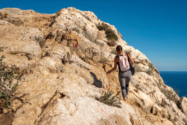 istock Woman hiking up the mountain 1284366824