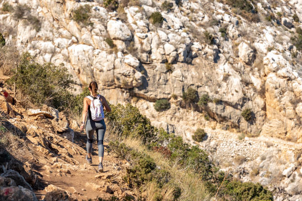 istock Woman hiking up the mountain 1284366863