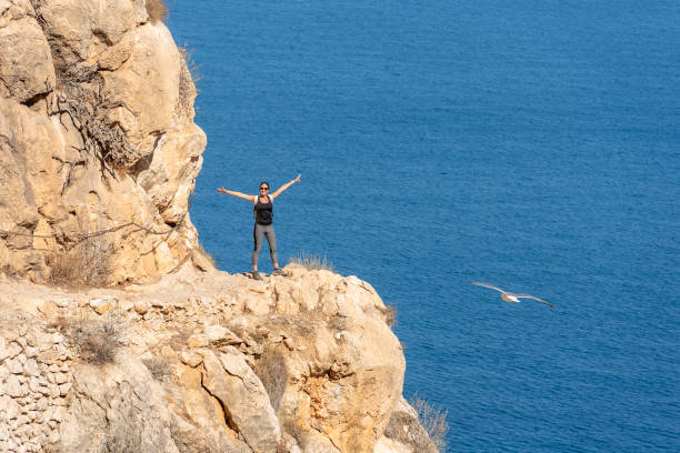 istock Woman hiking up the mountain 1284366911