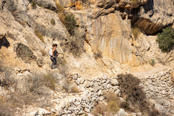 istock Woman hiking up the mountain 1284366929