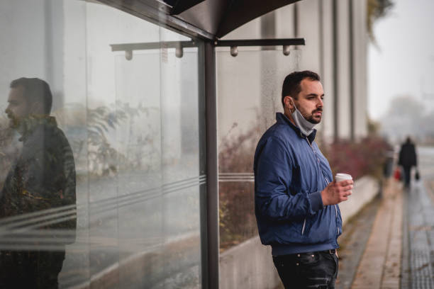 istock Young man waiting for transportation on a bus station 1284367087