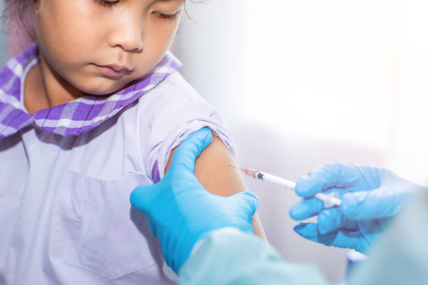 istock Immunization and vaccination for flu shot, influenza virus, HPV virus or Covid-19 prevention with young child girl in the school having vaccine injection for World immunization week and International HPV awareness day. 1284368089