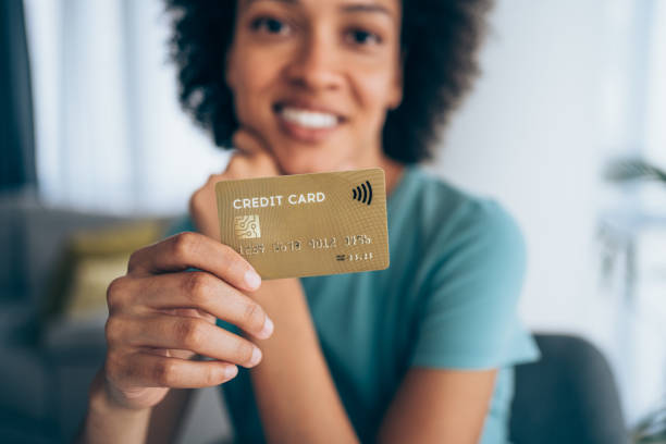 Woman holding a credit card.
