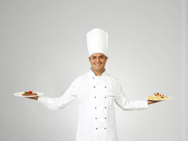 istock Chef holding meat dish and pasta 1284372128