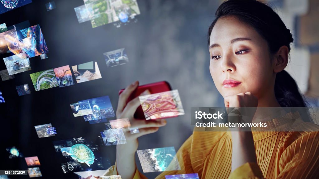 Young asian woman watching a lot of movies. Digital transformation. Movie Stock Photo