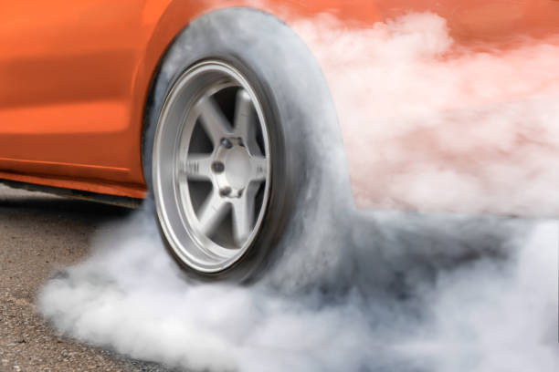 Race drift car burning tires on playground Race drift car burning tires on  playground drag racing stock pictures, royalty-free photos & images