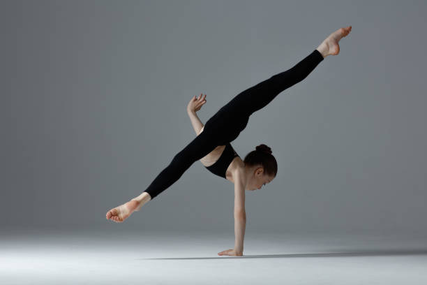 istock Female child gymnast stretching and training 1284373755