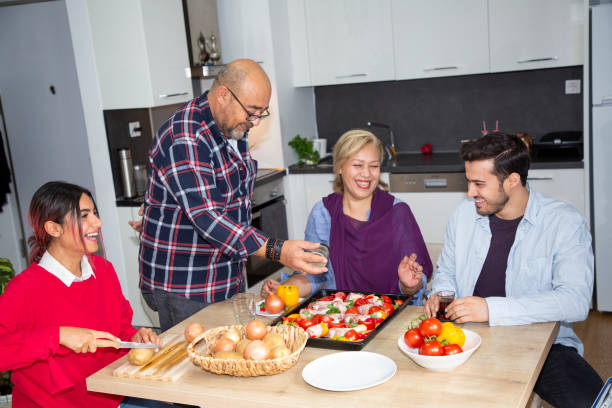 istock Happy family in the kitchen at dinner time 1284375217