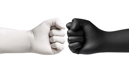 close up of a hand fist with black latex protective gloves on white background