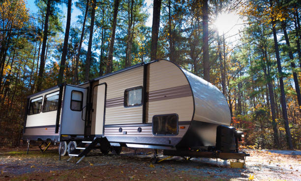 RV campsite at Jordan Lake North Carolina in late fall Mid day at a travel trailer campsite in autumn at Jordan Lake NC camper trailer photos stock pictures, royalty-free photos & images