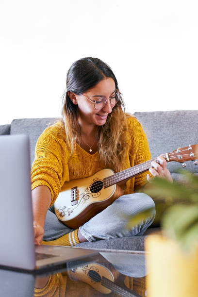 istock Woman taking ukulele lessons online 1284378528